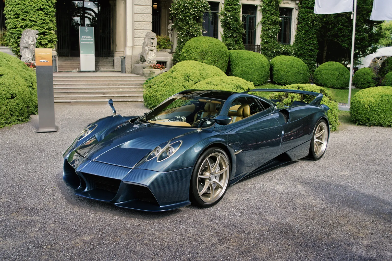Blue Pagani Huayra in front of a historic villa