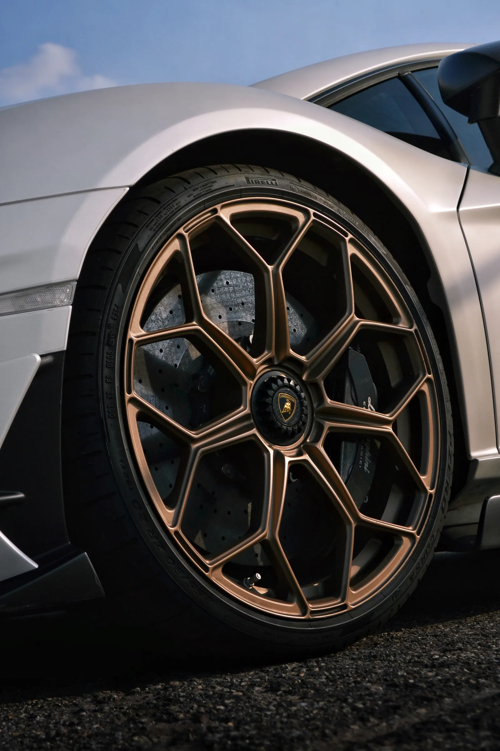 Close-up of a bronze wheel on a silver Lamborghini